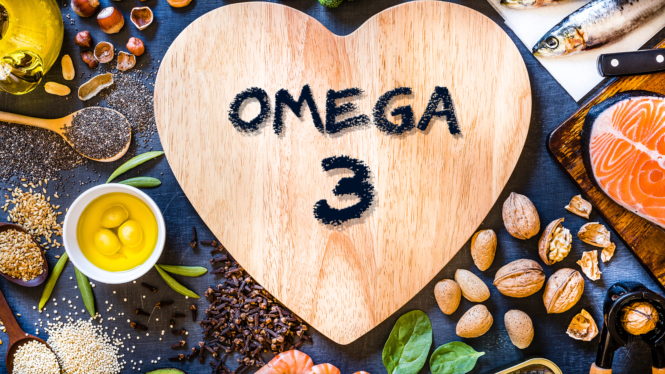 Heart-shaped board with Omega 3 text surrounded by fish, nuts, seeds, and oil