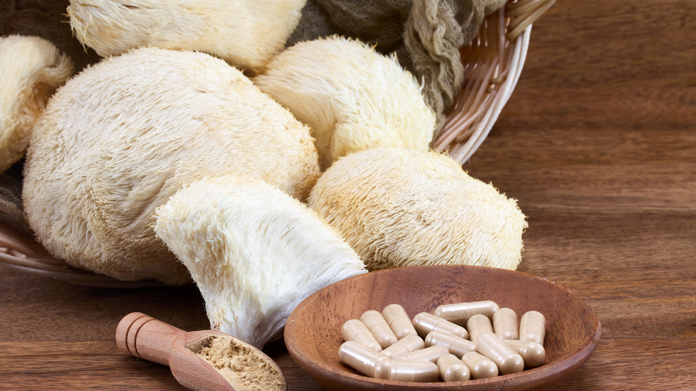 Fresh lion’s mane mushrooms with capsules and powder