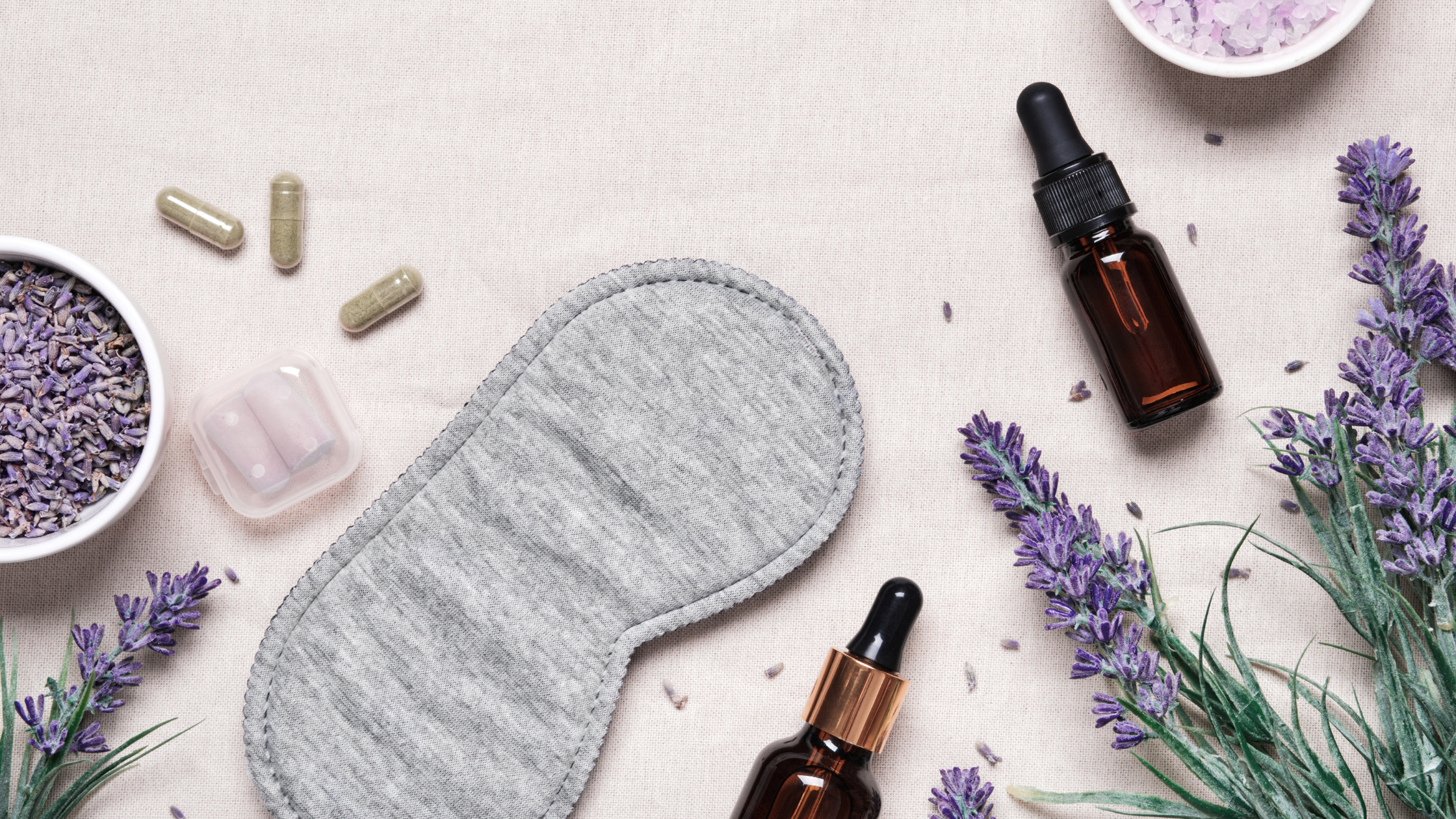Sleep mask with lavender, capsules, and essential oil bottles