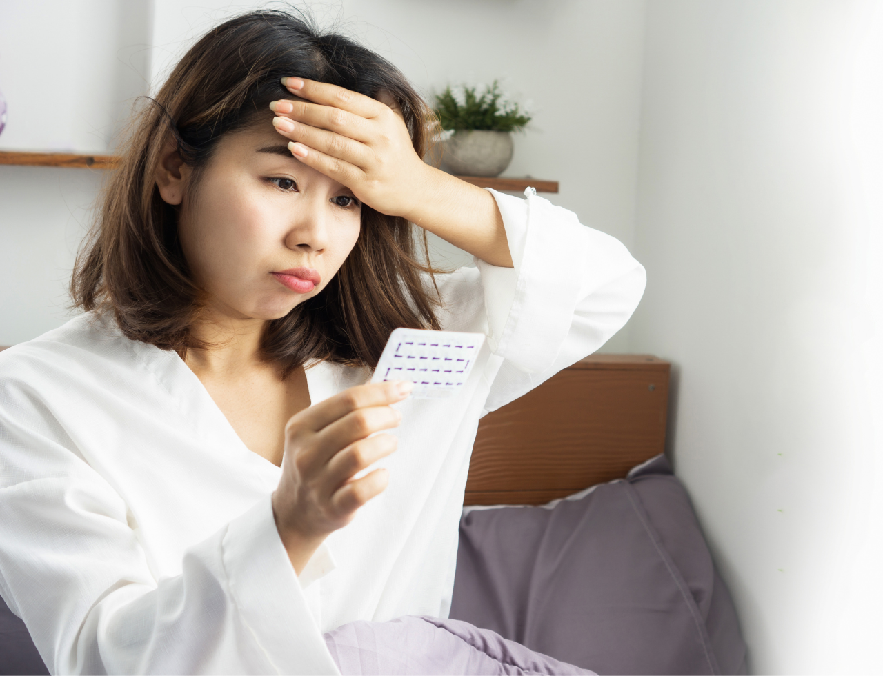 Woman looking concerned at medication blister pack