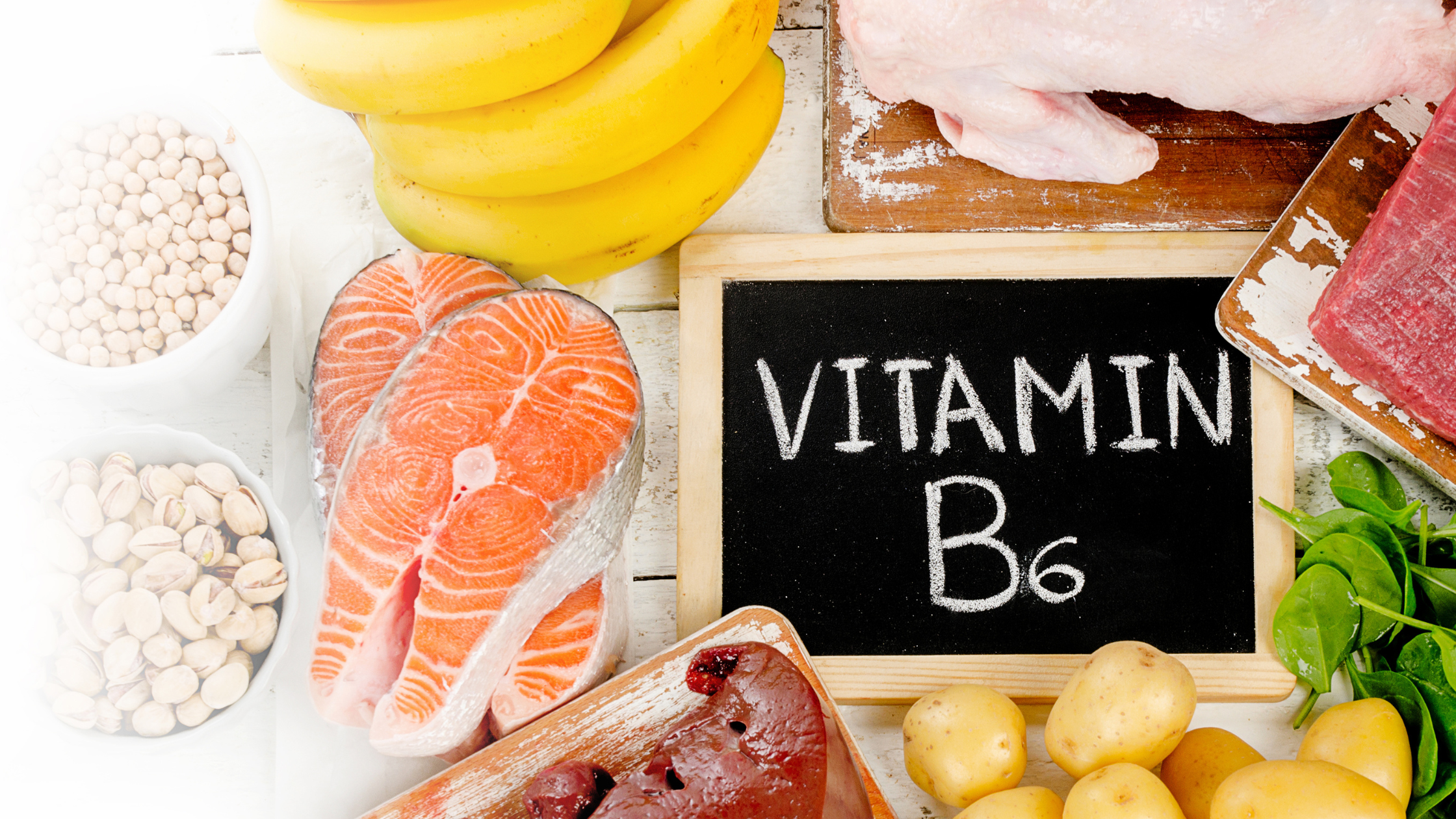 Chalkboard with Vitamin B6 surrounded by bananas, salmon, meat, potatoes, and spinach