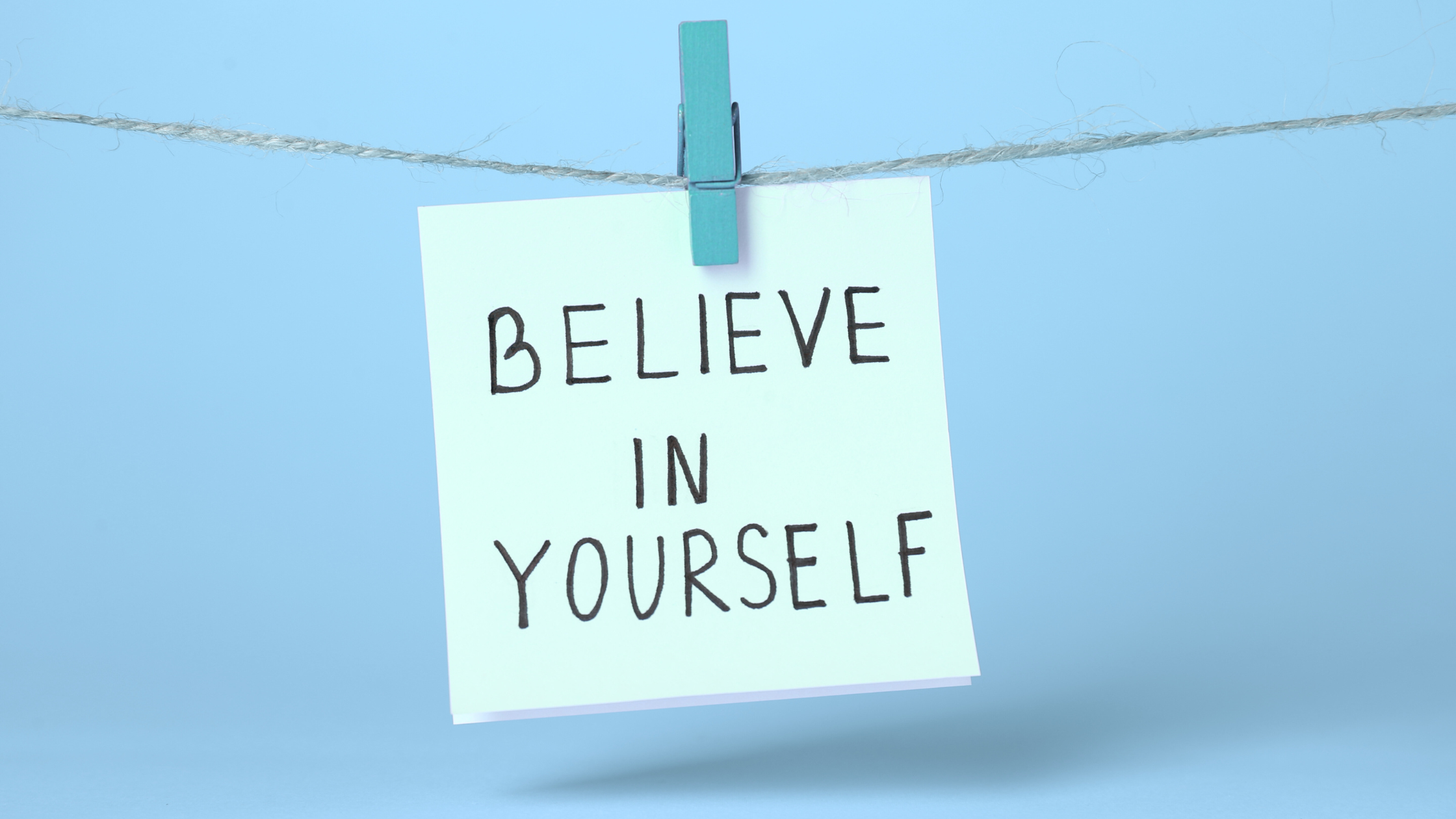 Note with handwritten text saying Believe in Yourself
