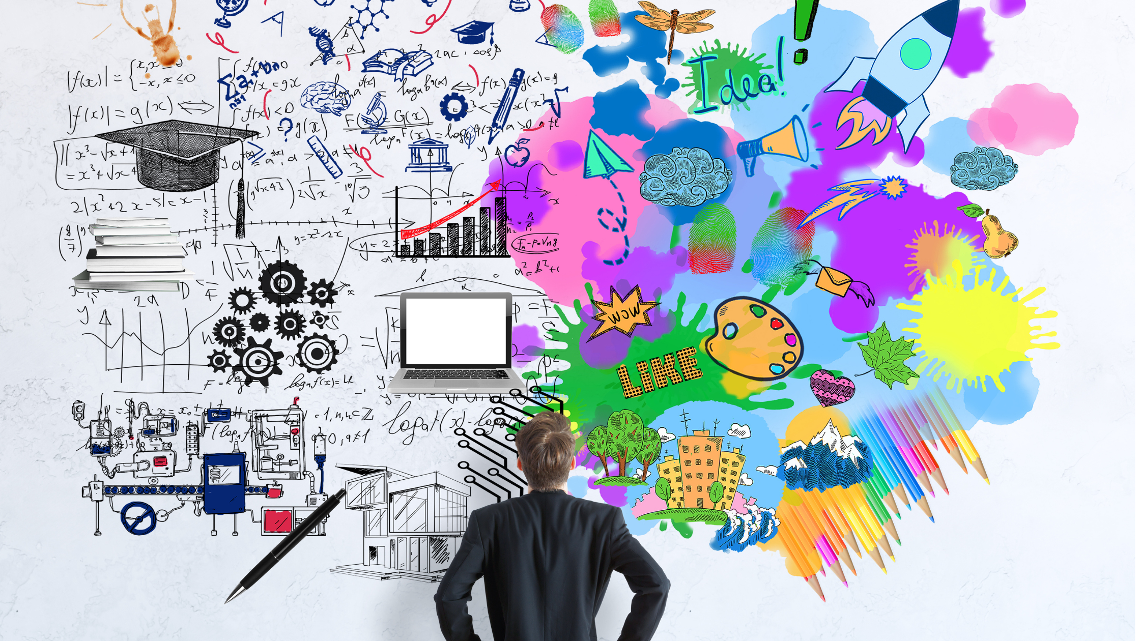Man looking at colorful creative and technical doodles on wall