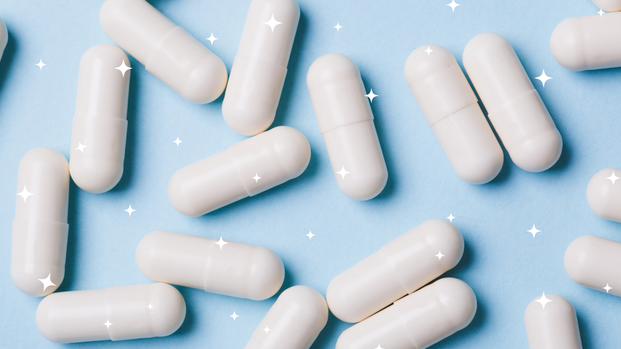 White capsules scattered on a blue surface with sparkle effects