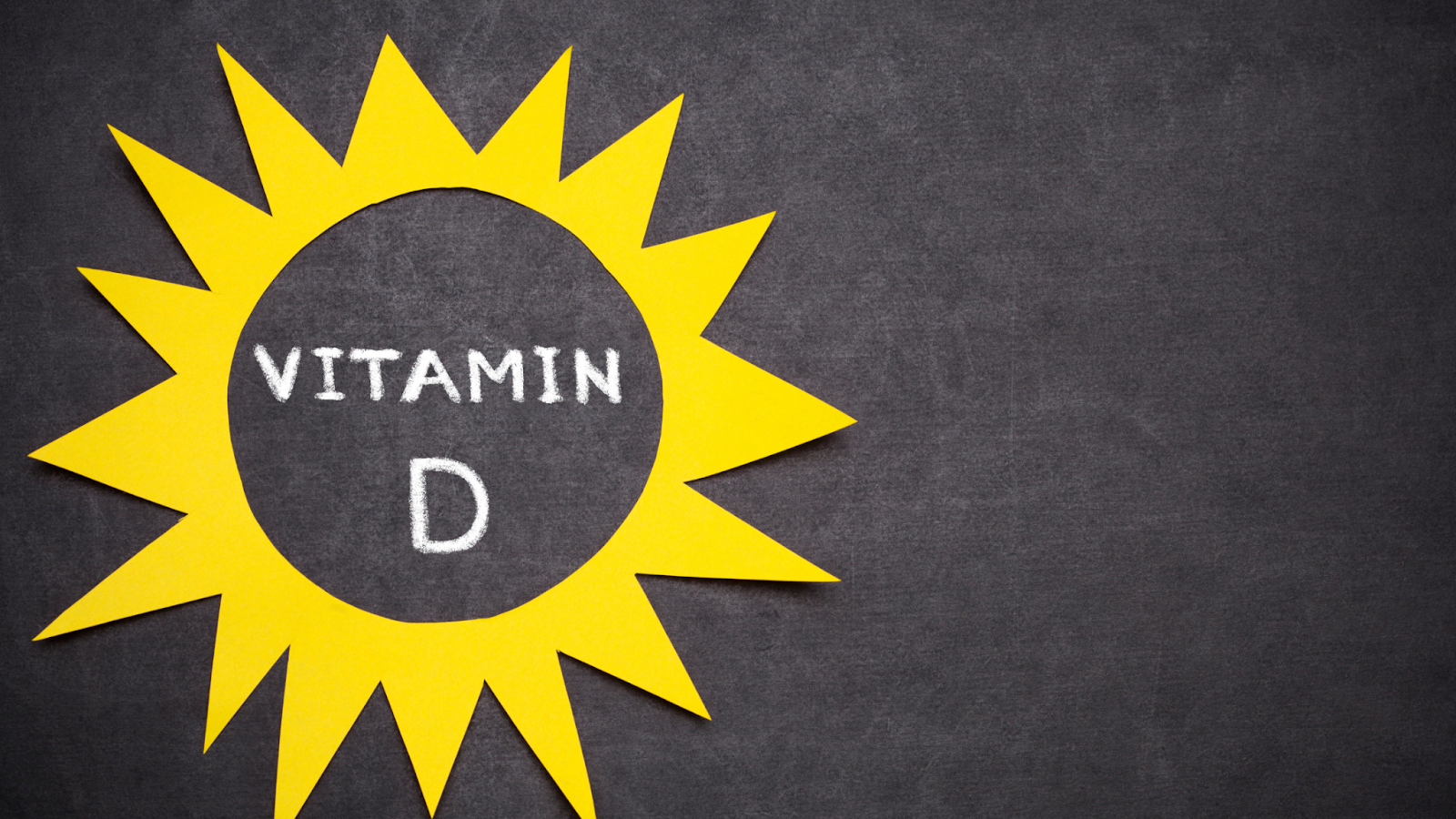 Yellow sun cutout with Vitamin D text on blackboard