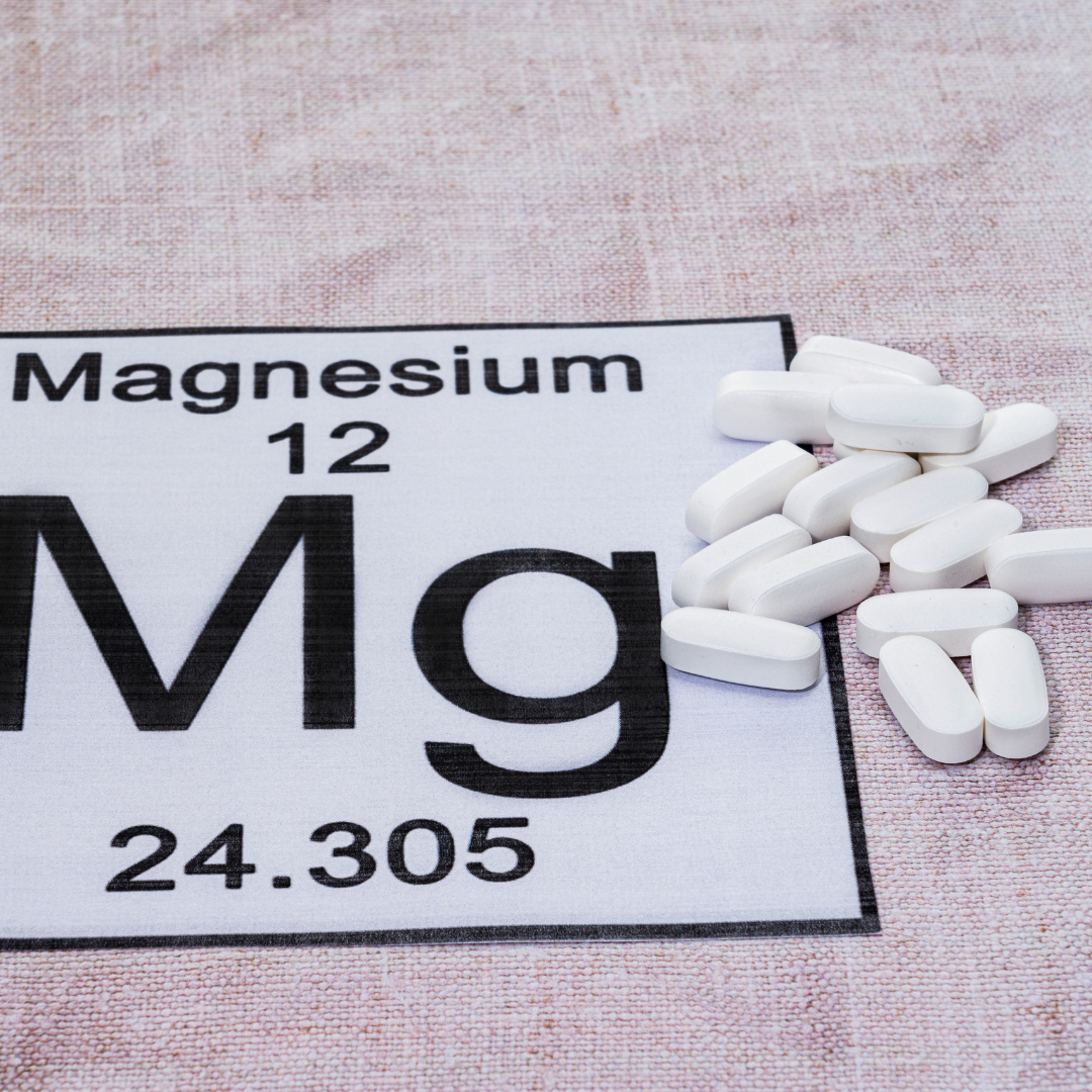 White magnesium supplement tablets on periodic table element card