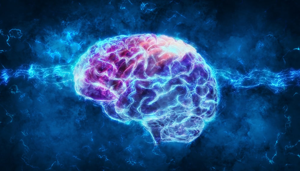 Glowing digital illustration of a human brain with electric sparks