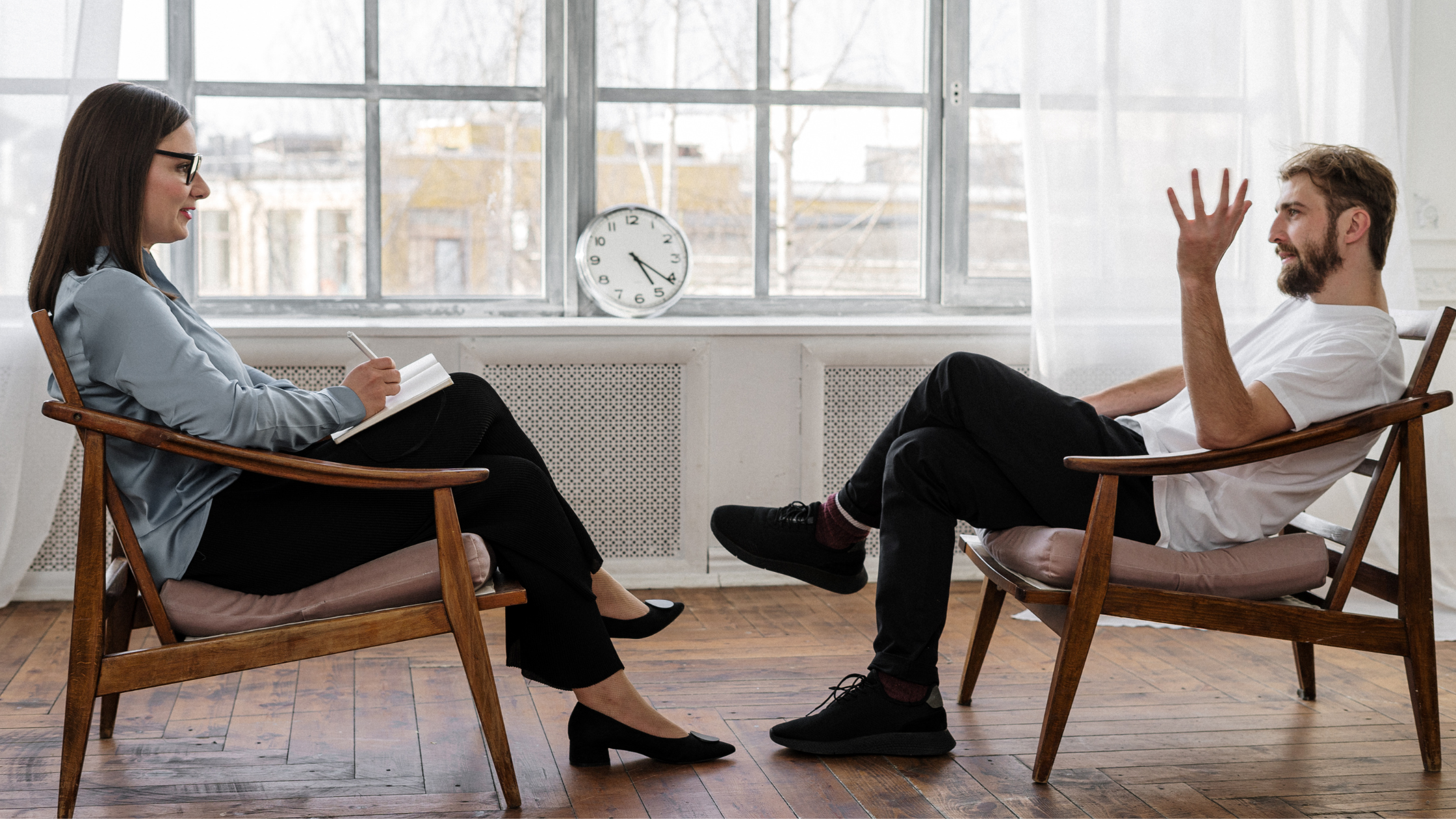 Therapist taking notes while client talks in session