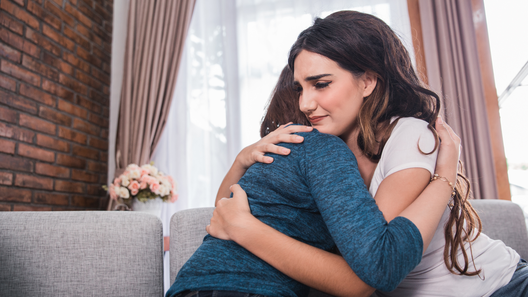Two women comforting each other with a hug