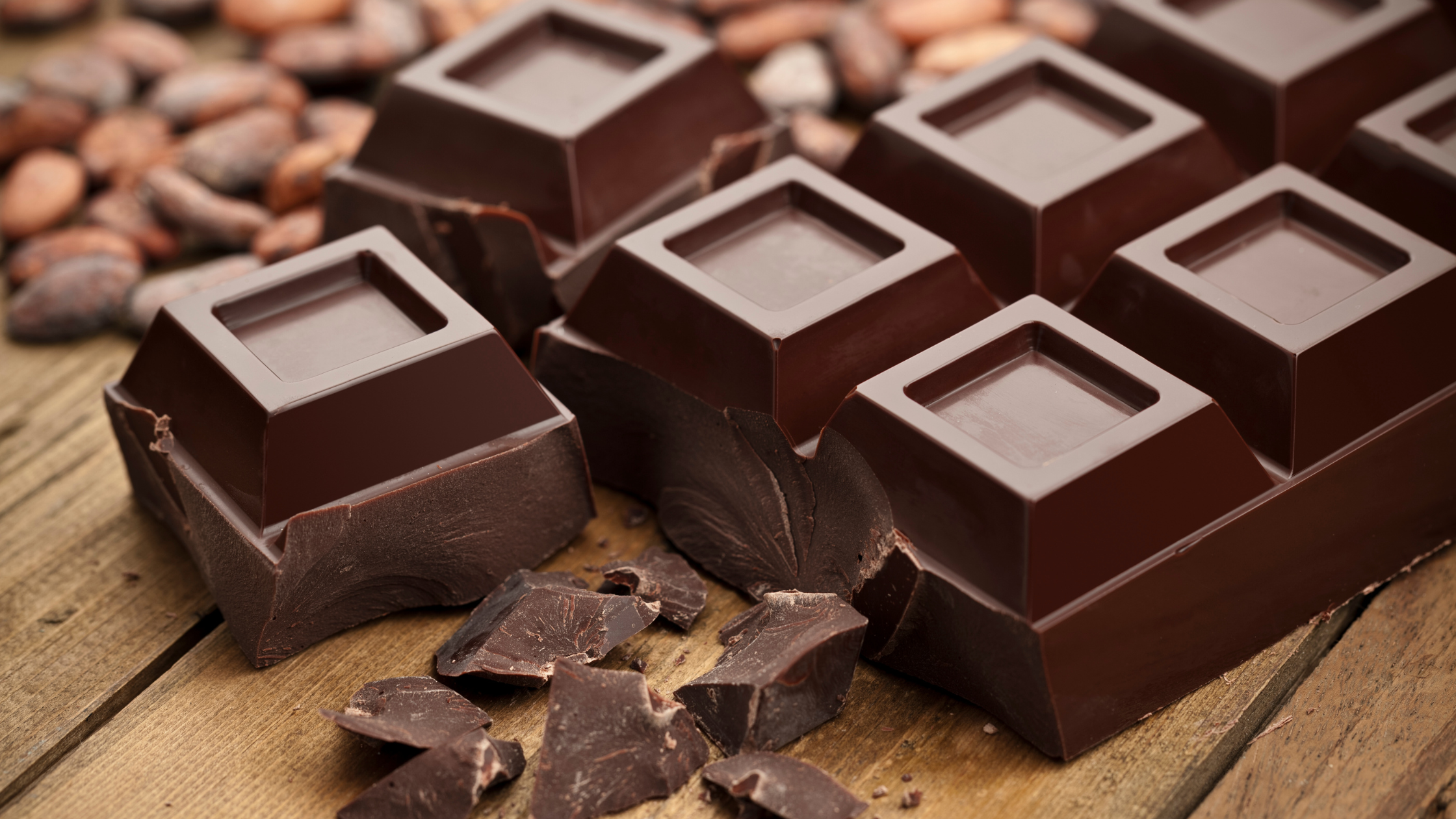Close-up of dark chocolate bar with cocoa beans