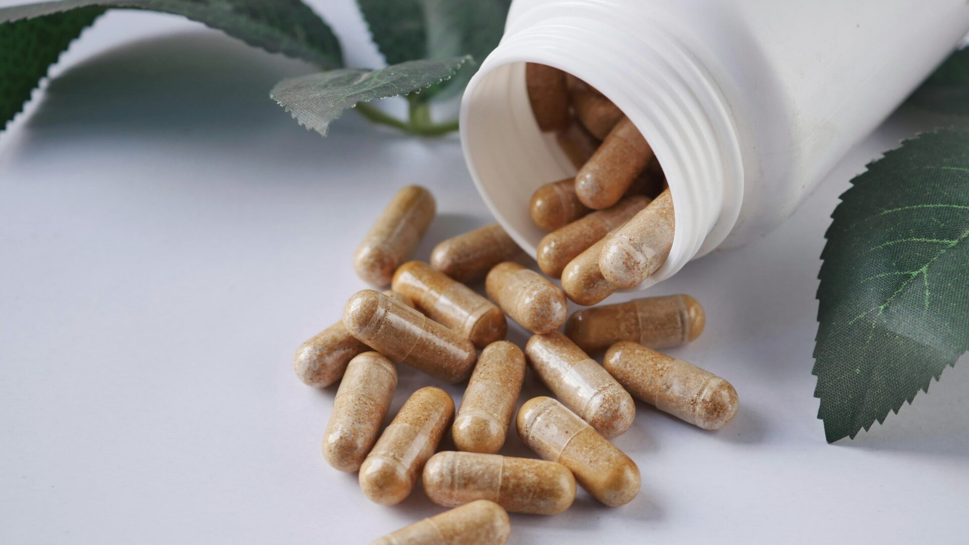 Bottles of adaptogens and nootropics supplements arranged on a table, highlighting natural herbs and capsules used for stress relief and cognitive support.