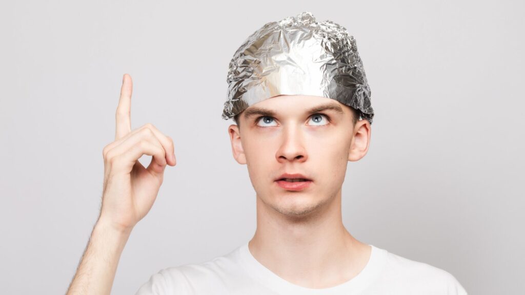 Illustration showing a person experiencing delusional disorder, with thought bubbles depicting fixed false beliefs despite evidence to the contrary.