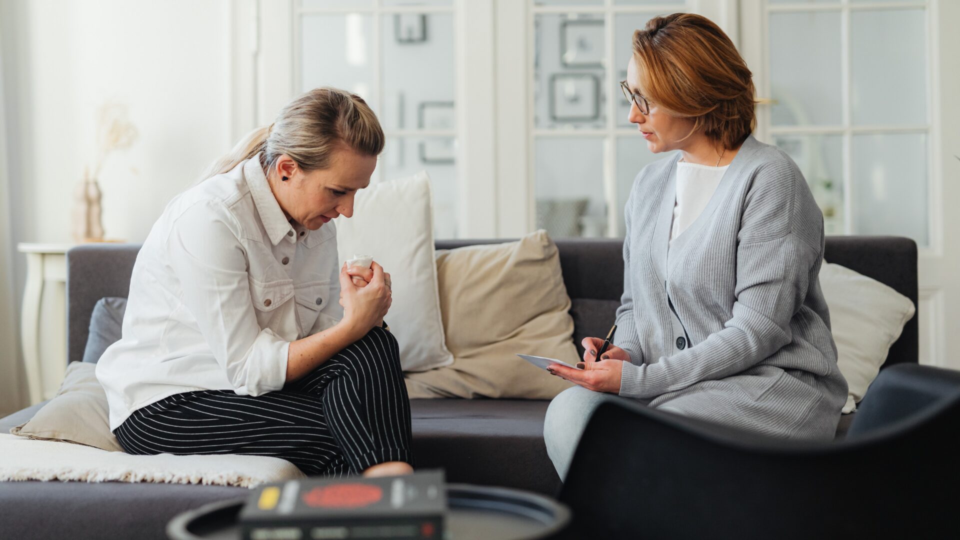 A therapist and client engage in interpersonal therapy (IPT), focusing on improving communication skills and addressing relationship issues in a clinical setting.