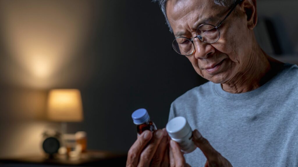 A bottle of dietary supplement labeled for memory loss support, featuring capsules and natural ingredients like ginkgo biloba and omega-3 on a white background.