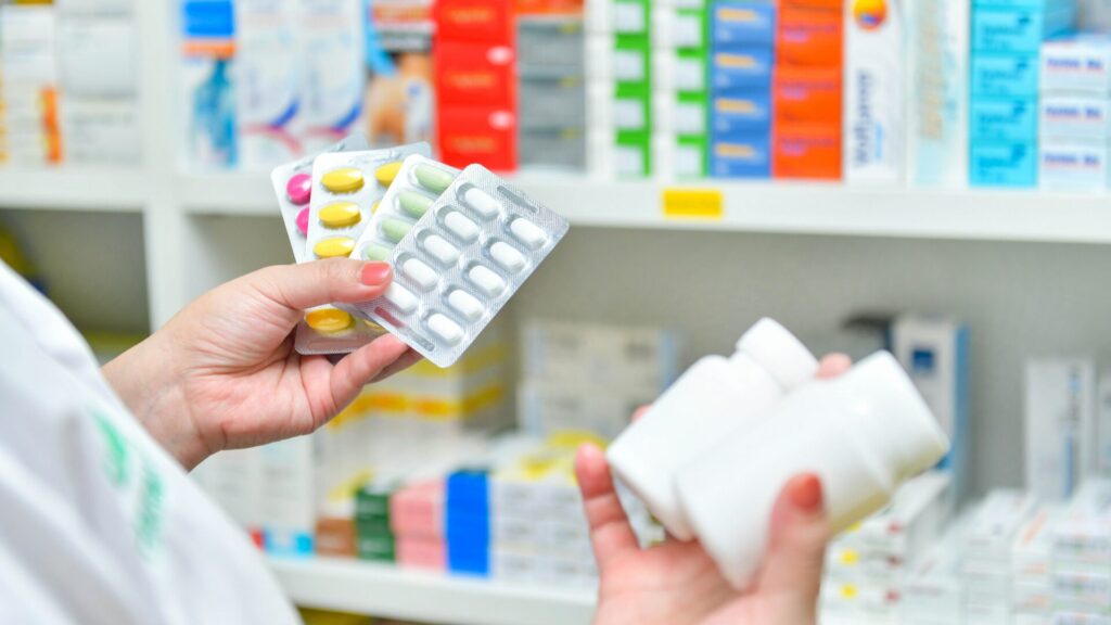 A selection of popular over-the-counter sleep aids, including melatonin, diphenhydramine, and herbal supplements, displayed on a pharmacy shelf.