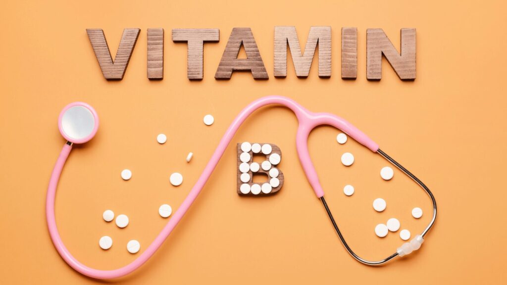 Whole Food Vitamin B Complex supplement capsules in a clear bottle, featuring natural ingredients and labeled for energy and stress support on a wooden table.