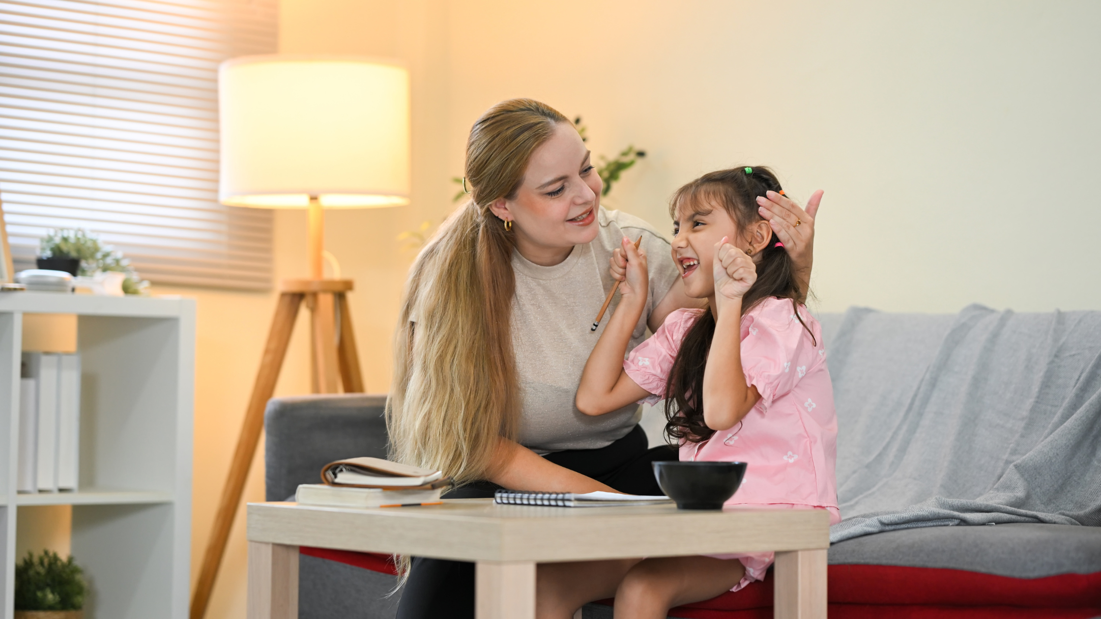 Woman and child smiling and interacting on a couch