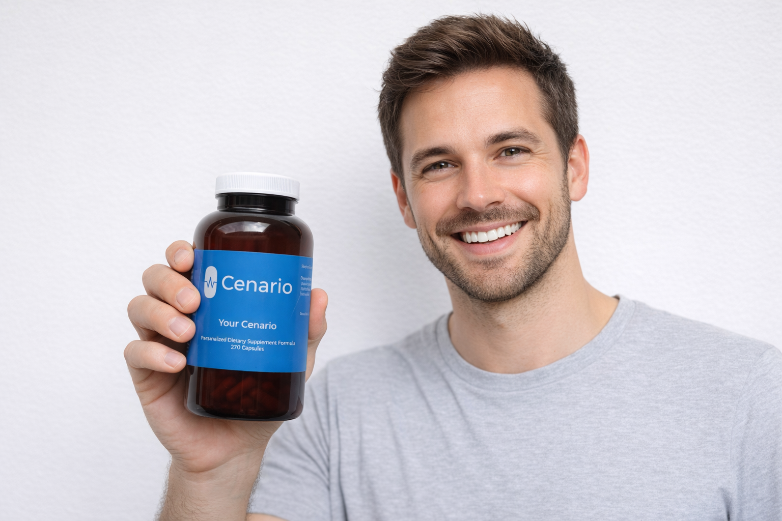 Smiling man holding a bottle of Cenario supplements