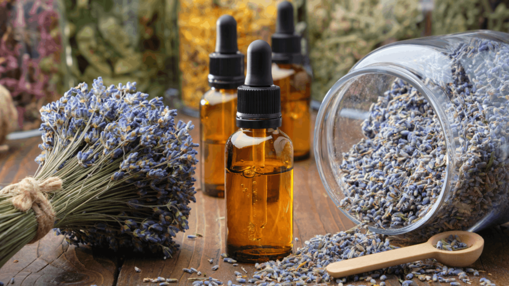 A selection of the best essential oils for sleep, including lavender, chamomile, and cedarwood, displayed in glass bottles with fresh herbs nearby.