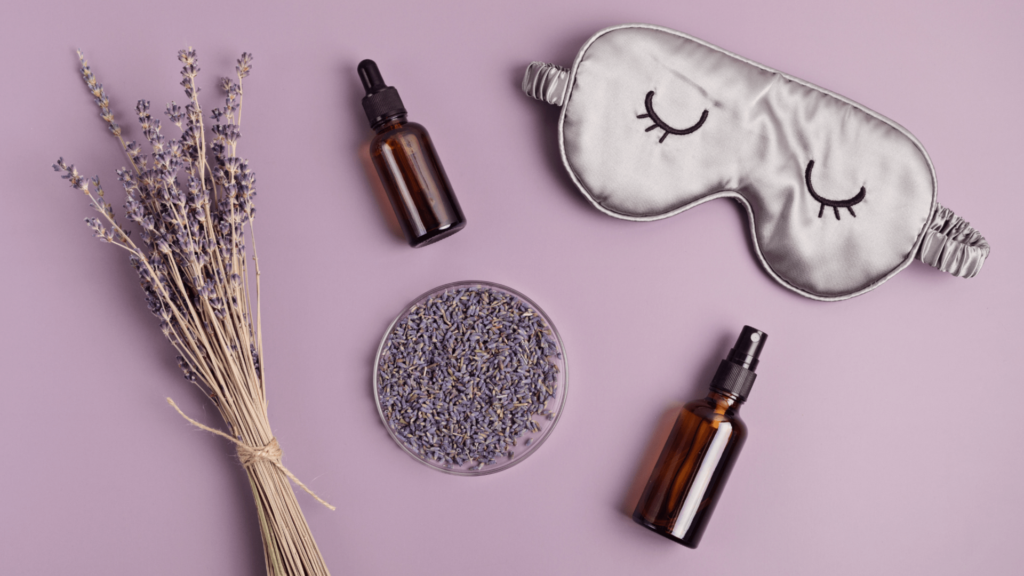A selection of essential oils for sleep, including lavender, chamomile, and sandalwood, arranged on a bedside table with a diffuser and soft lighting.