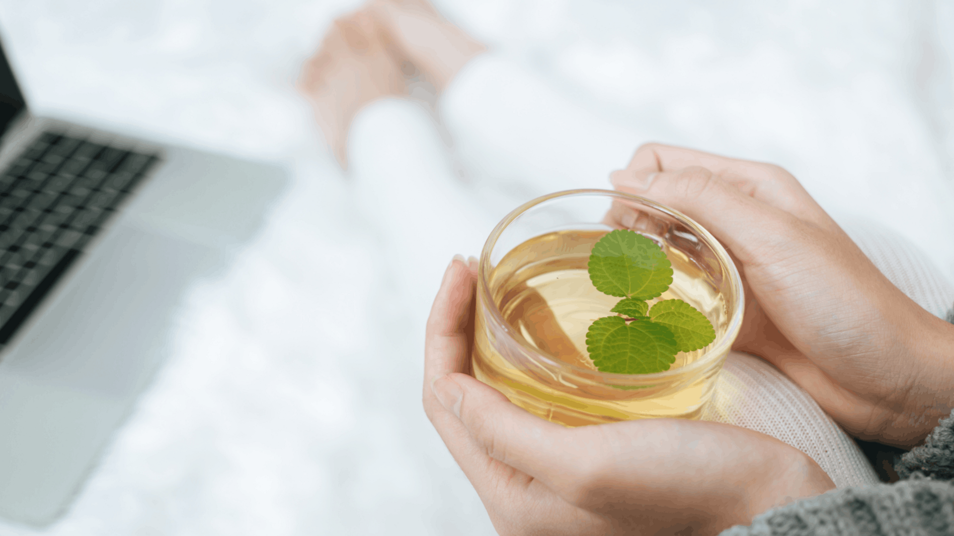 A cup of herbal tea for sleep with chamomile flowers and dried herbs on a wooden table, promoting natural relaxation and restful nighttime routines.