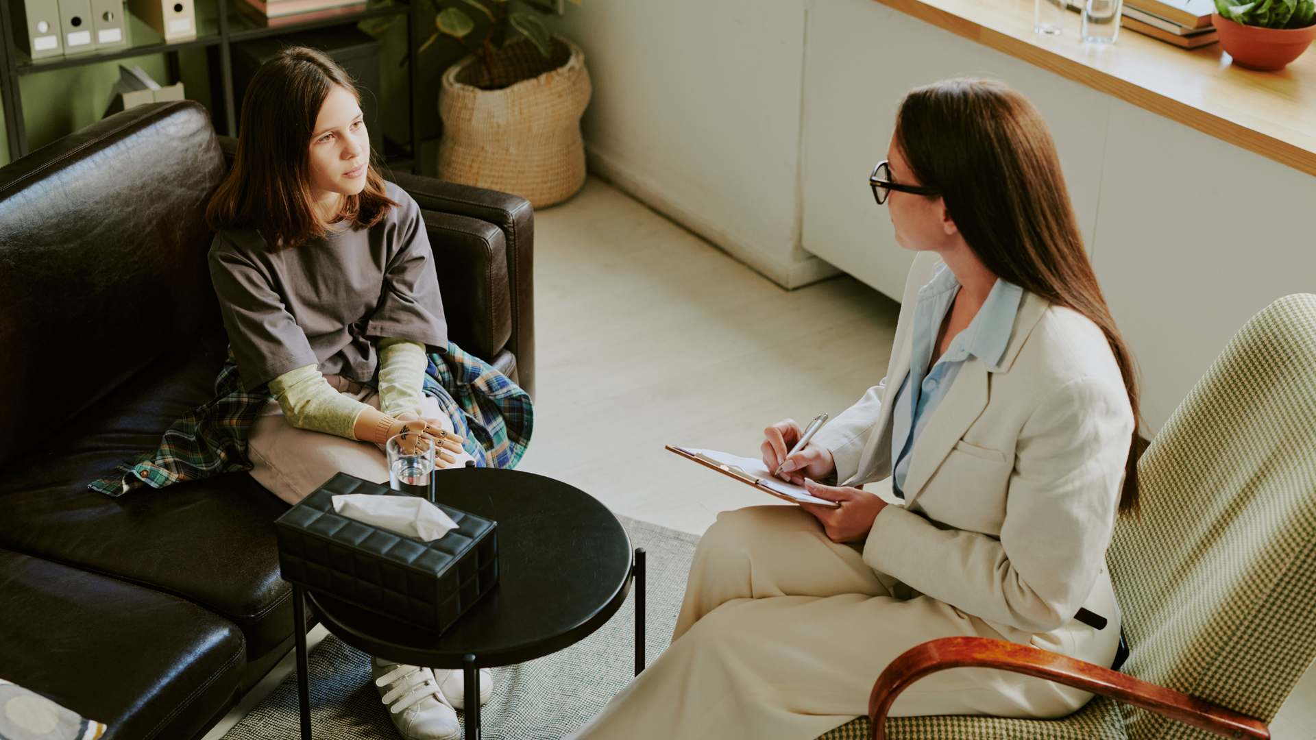 A person searching online for how to find a therapist, reviewing therapist profiles and contact information on a laptop in a comfortable home setting.