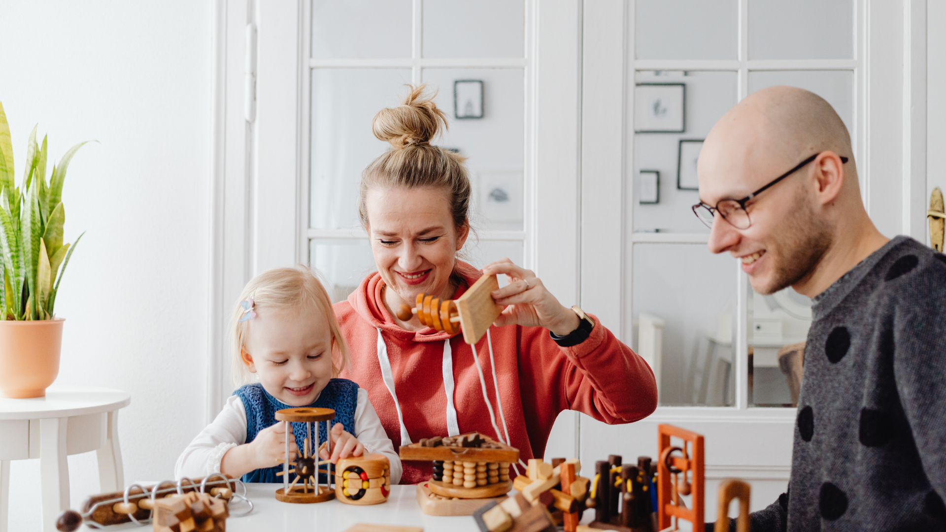A therapist guides a parent and child through structured play activities during a Parent-Child Interaction Therapy session to improve communication and behavior.