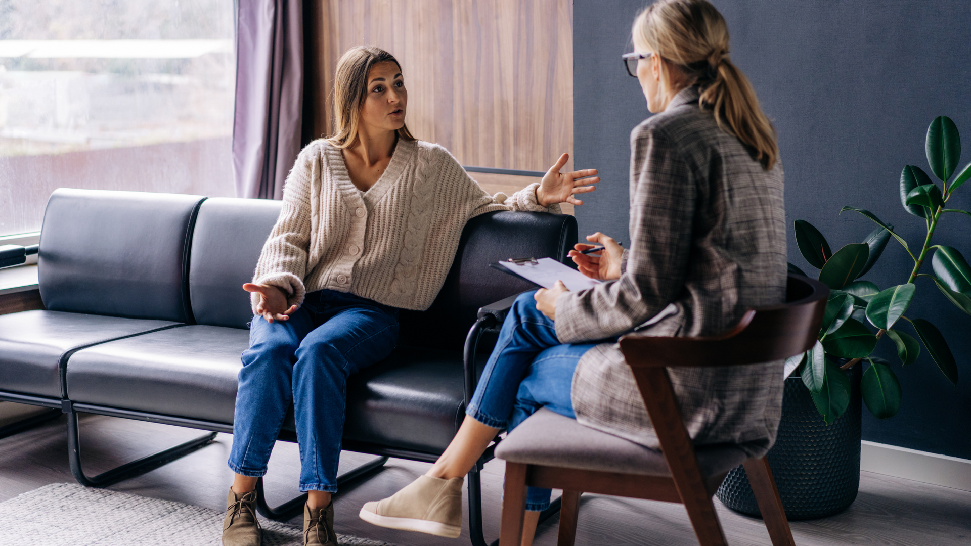 A therapist and client sit across from each other in a cozy office, engaging in small talk therapy to build rapport and ease into deeper conversation.