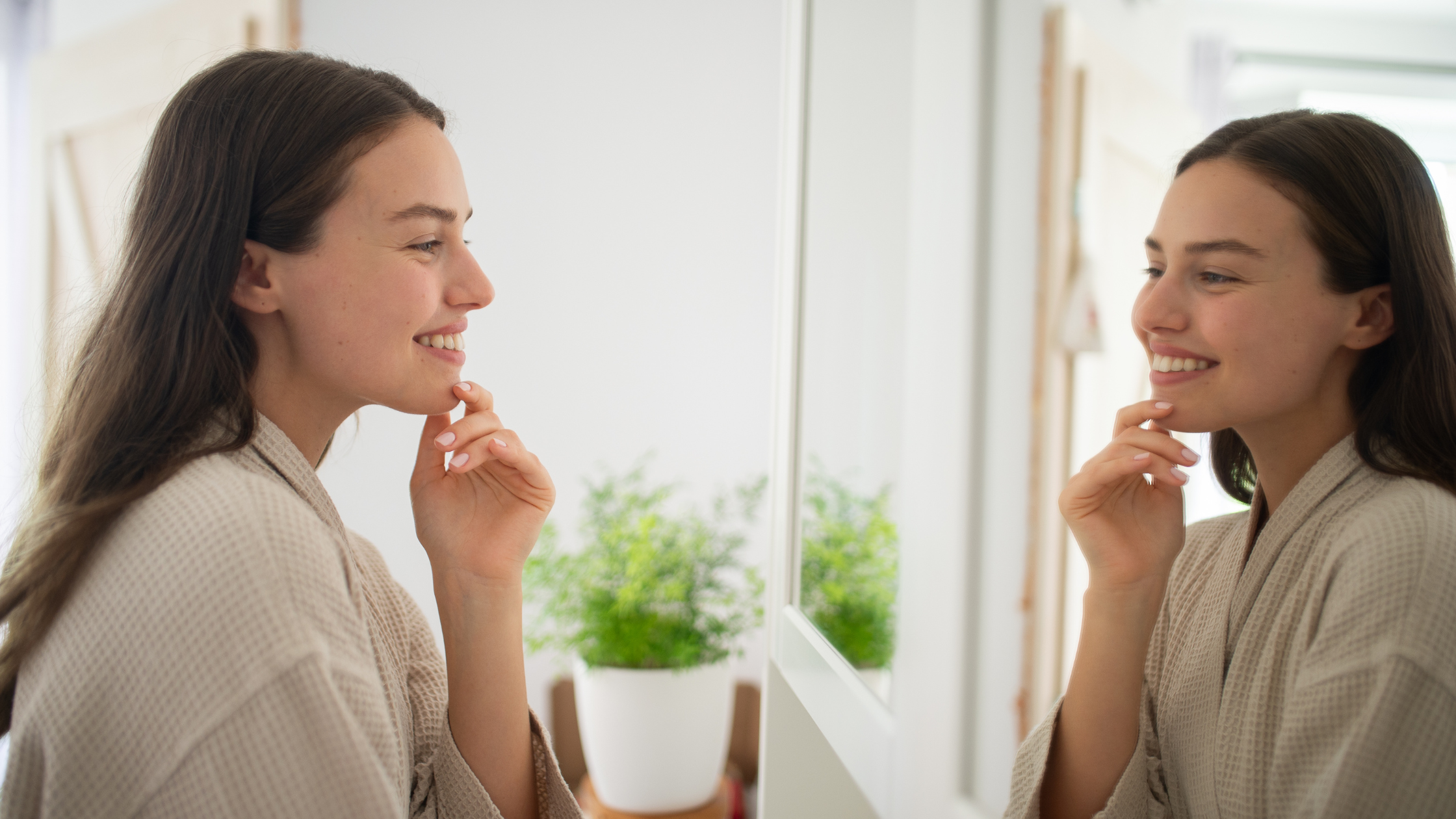 Smiling woman looking at herself in a mirror