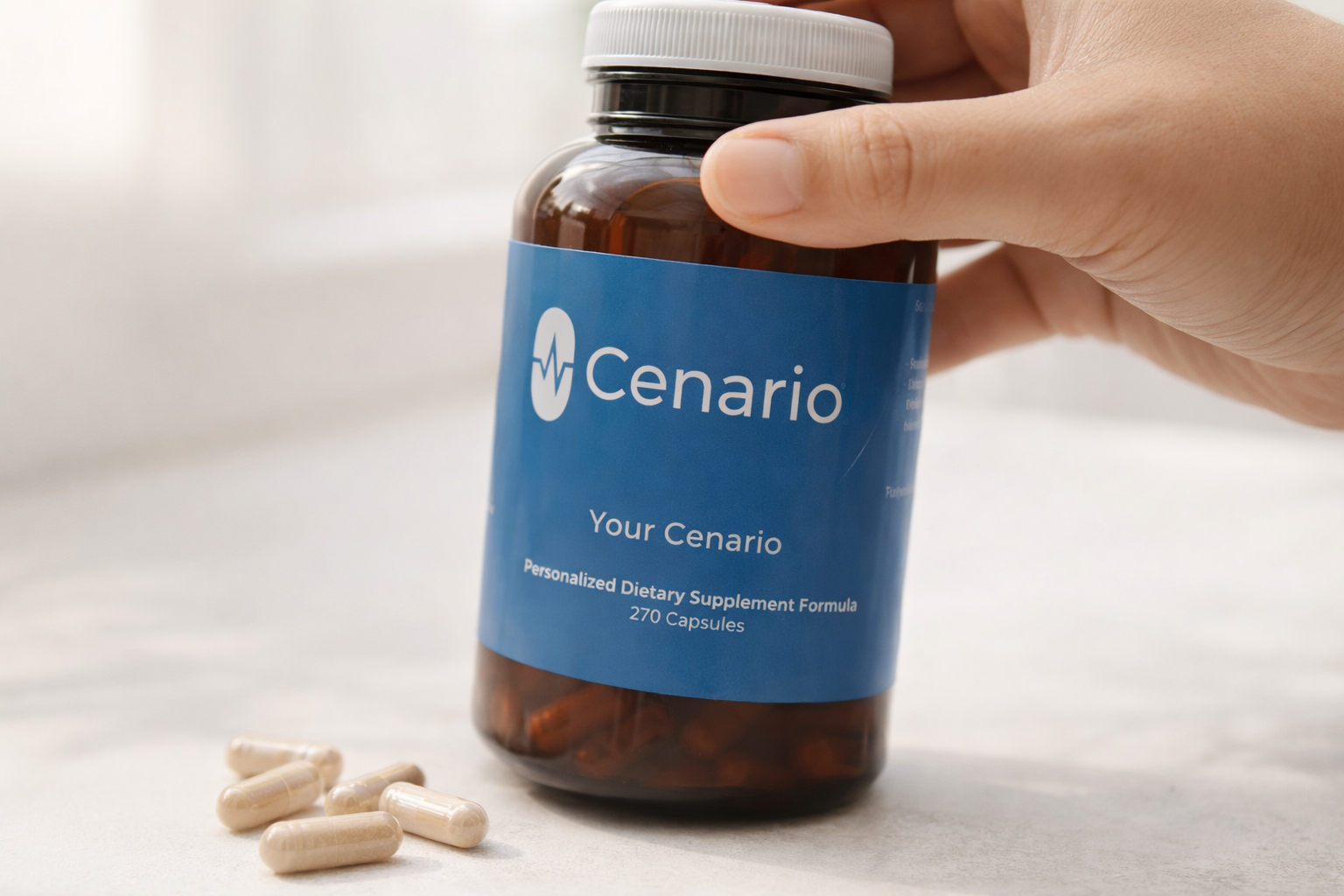 Hand holding Cenario dietary supplement bottle with capsules nearby