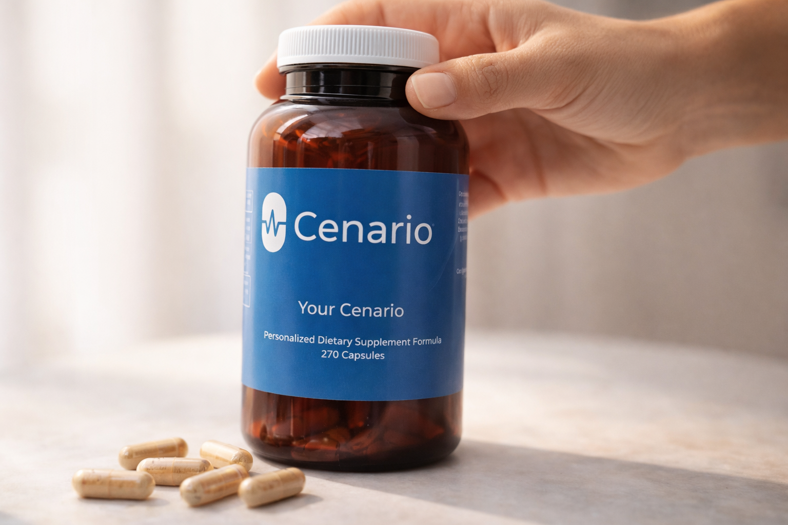 Hand holding Cenario supplement bottle with capsules on table