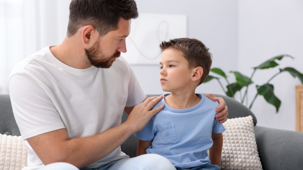 A young child sits alone with a sad expression, illustrating symptoms of bipolar disorder in children, such as mood swings and emotional distress.