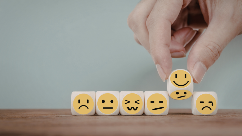 A person practices emotional self regulation by taking deep breaths and pausing to manage stress, maintaining calm and control in a challenging situation.