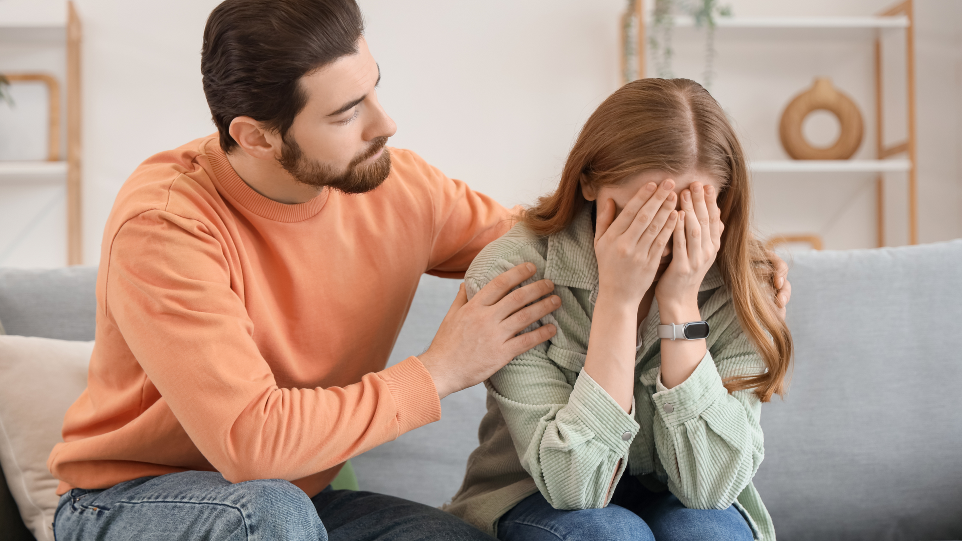A person gently holding their partner’s hand, offering comfort and support while sitting together, symbolizing help for a partner with depression.