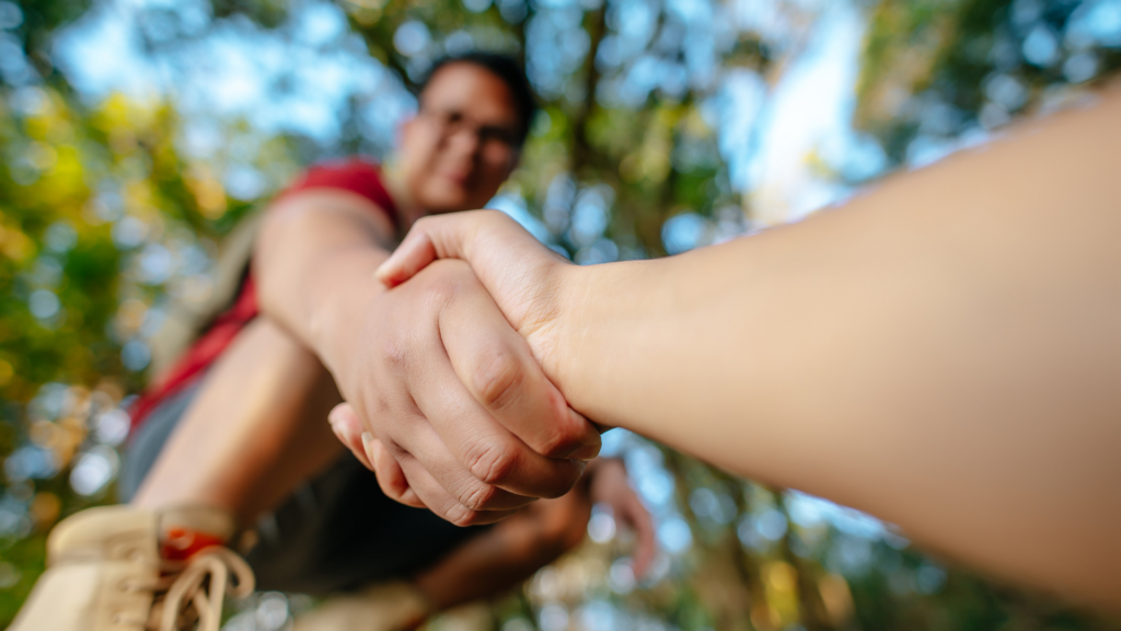 A person helps an elderly woman cross the street, illustrating altruism through selfless concern for the well-being of others in everyday life.