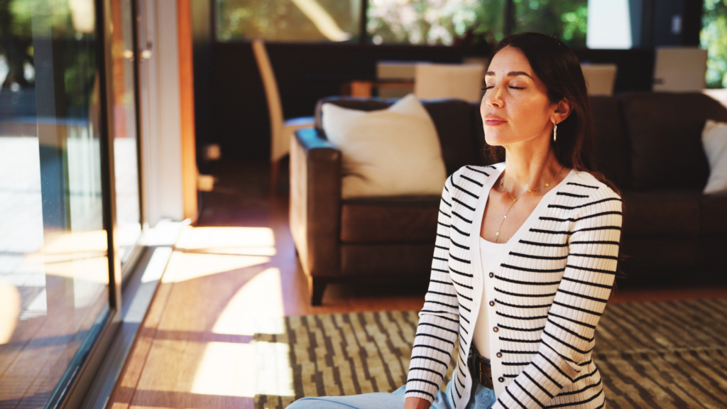 A person practices box breathing therapy, inhaling, holding, exhaling, and pausing in equal counts to reduce stress and promote relaxation.