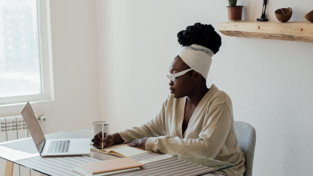 A person sits comfortably with a notebook, using ChatGPT prompts for therapy to explore emotions and reflect on personal growth in a calming setting.