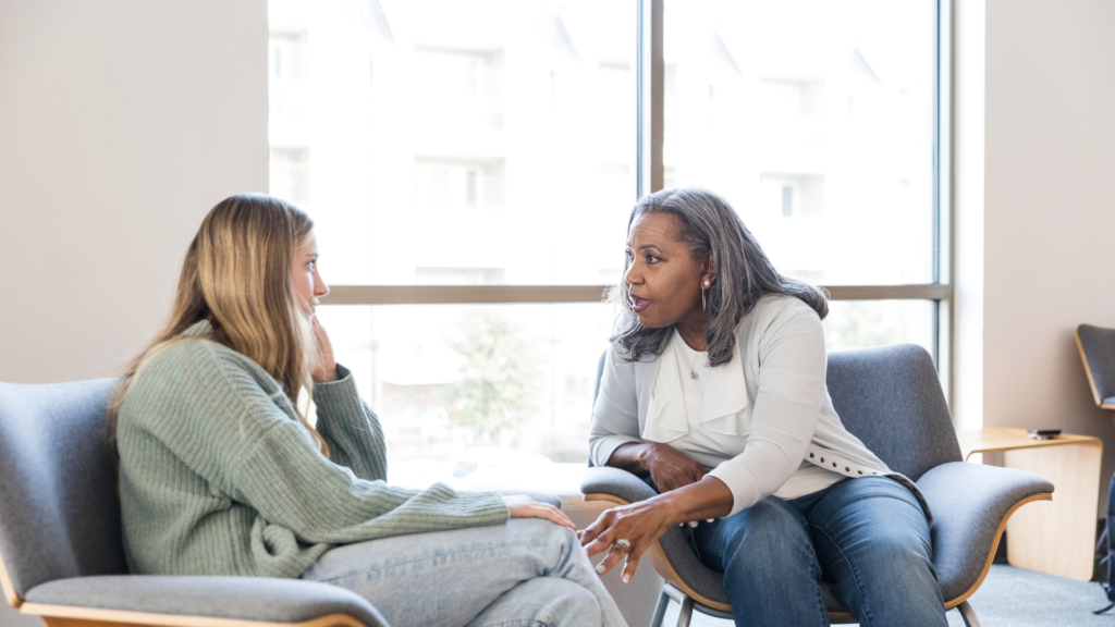 A therapist and client engage in existential therapy, exploring meaning, personal responsibility, and life choices in a supportive counseling setting.