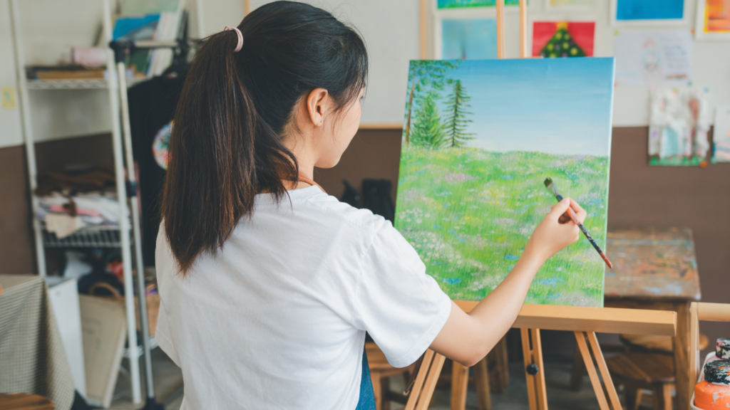 A therapist guides a client through expressive arts therapy, using painting and music to explore emotions and promote mental well-being in a calming studio.