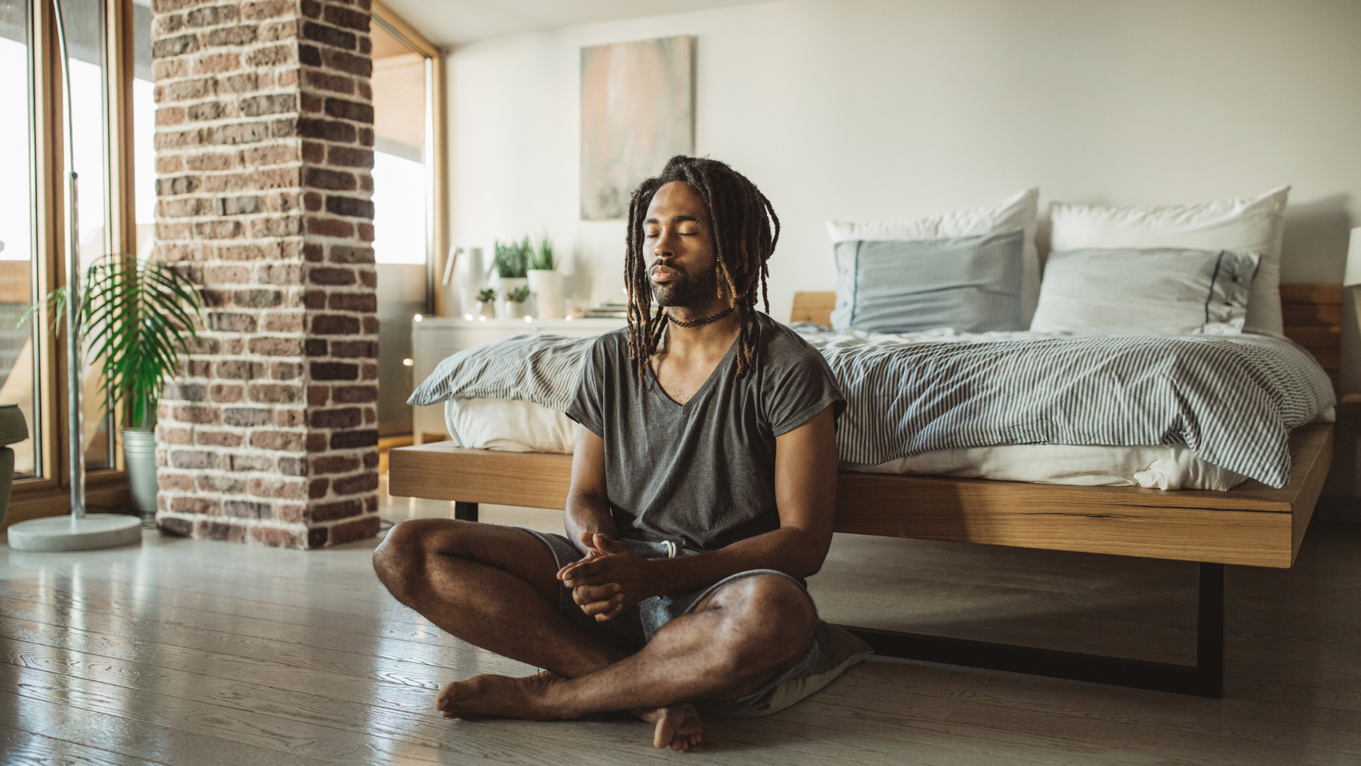A person sits peacefully in a sunlit room, practicing mindfulness meditation to support mental wellness and emotional balance.