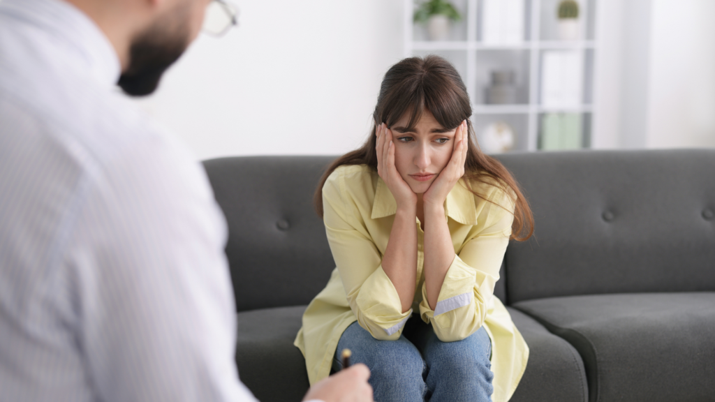 A therapist guides a client through exposure therapy and mindfulness exercises to help manage and reduce intense fear of death in a supportive setting.