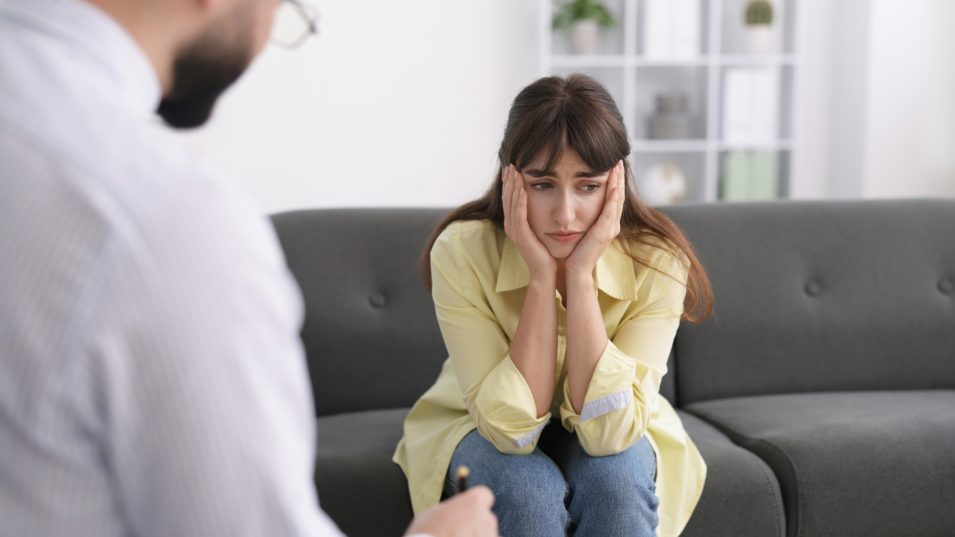 A therapist guides a client through exposure therapy and mindfulness exercises to help manage and reduce intense fear of death in a supportive setting.
