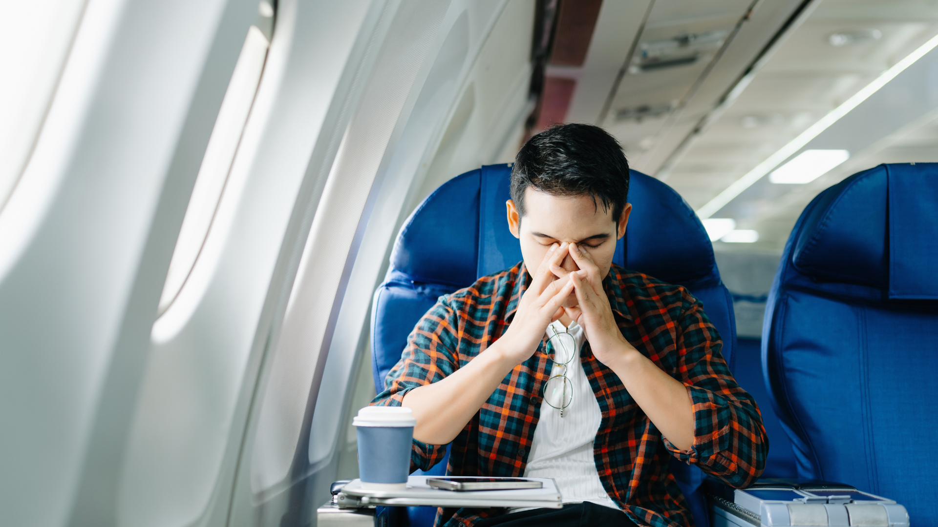 A therapist guides a client through relaxation techniques during a session focused on overcoming fear of flying, using calming visuals and supportive dialogue.