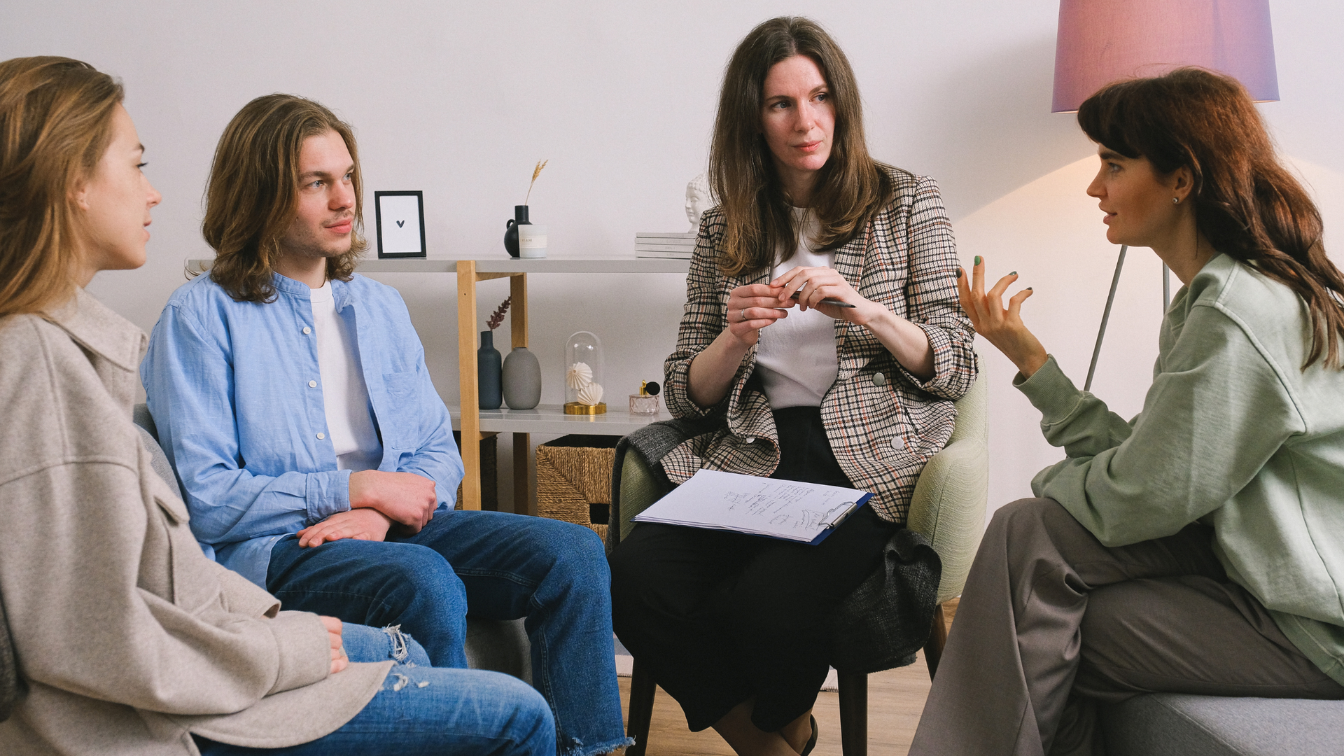 A person sitting cross-legged on a yoga mat, practicing mindfulness meditation in a peaceful room to support therapy for mental well-being.