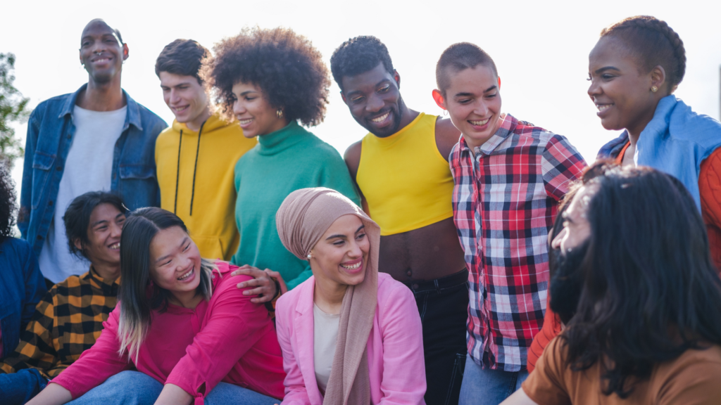 People from different cultures wearing traditional clothing, sharing food, and engaging in cultural exchange activities in a vibrant, diverse setting.