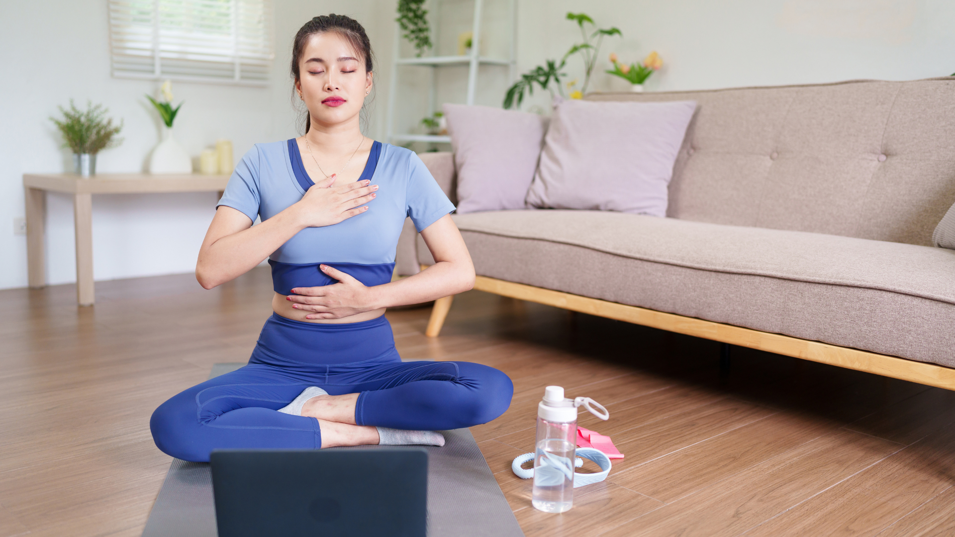 Person practicing diaphragmatic breathing, lying on their back with one hand on the chest and one on the abdomen, focusing on deep belly breaths.