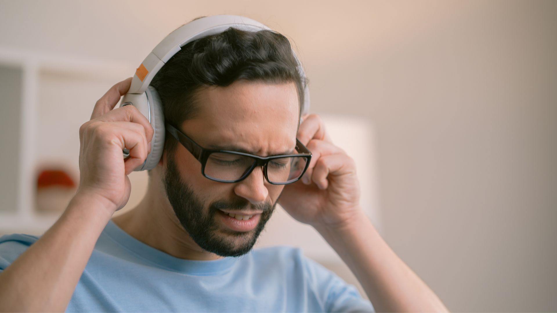 A person sits with hands over ears and eyes closed, surrounded by bright lights and loud noises, showing signs of being overstimulated and overwhelmed.